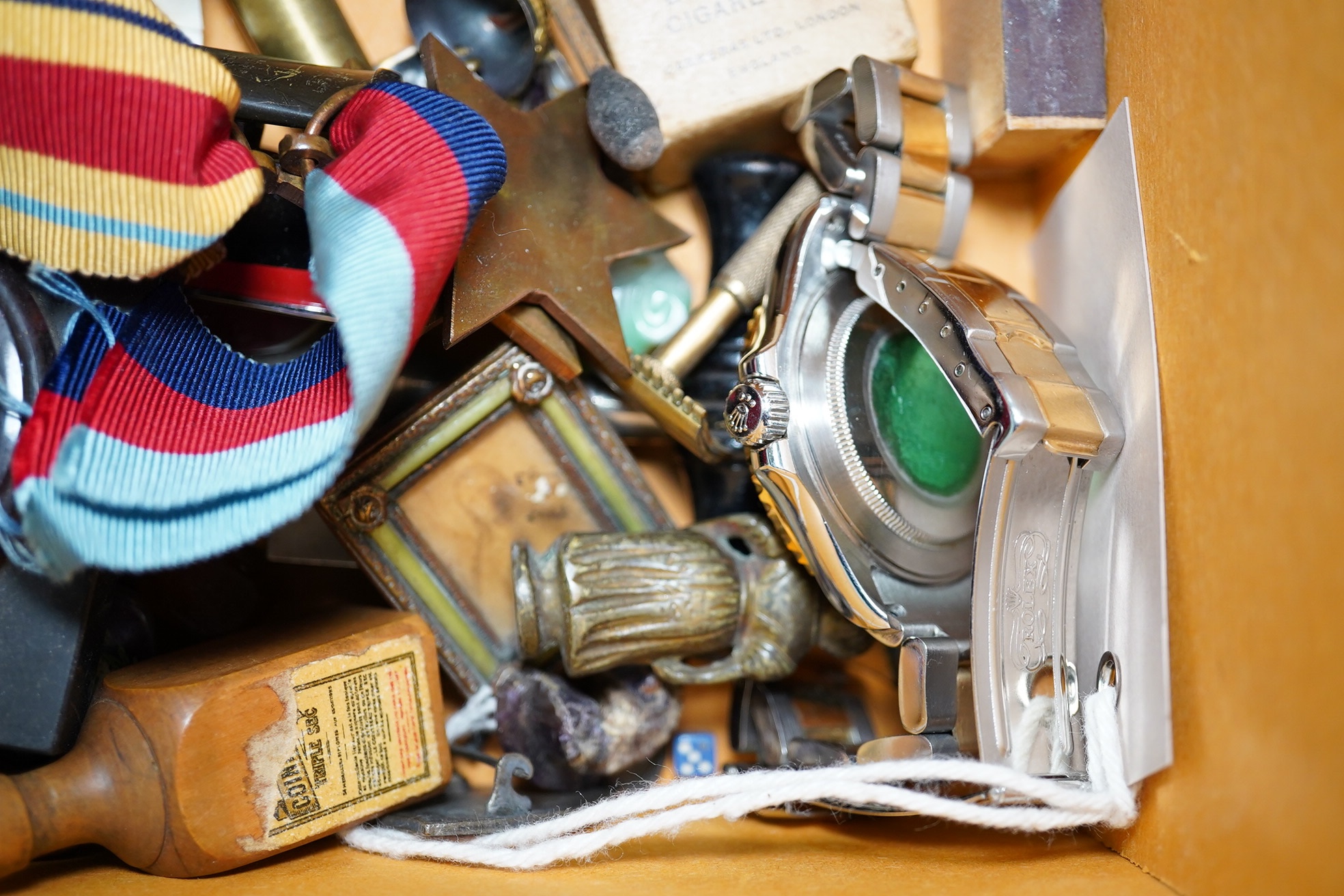 A box of assorted curiosities including vesta cases, one in the form of a skull, medals, section of Japanese inro and miniatures. Condition - varies